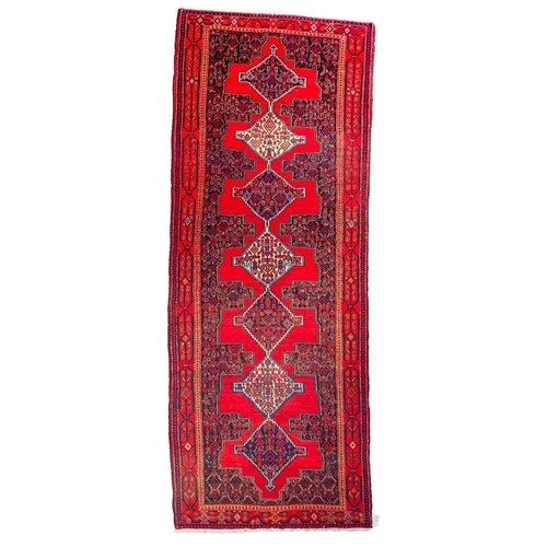 1198 - A Senneh Kelleh, the red field with a row of stepped and pointed lozenge medallions, indigo surround... 