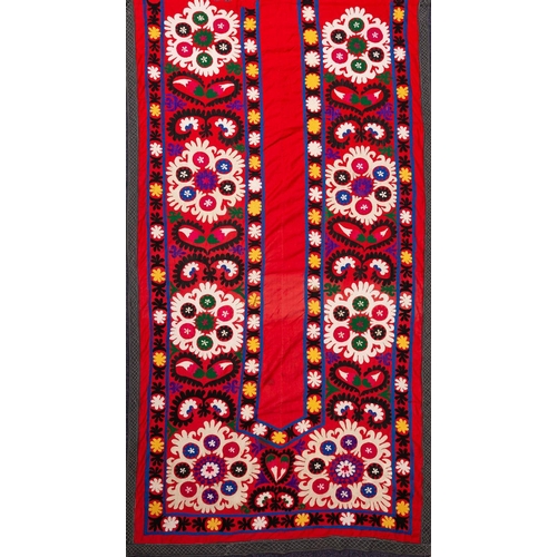 1199 - A North East Persian silk bed cover embroidered in the form of a prayer arch with panels of stylised... 