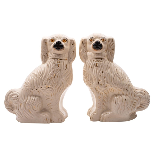 127 - A pair of large late C19th Staffordshire pottery figures of spaniels with painted muzzles and eyes, ... 