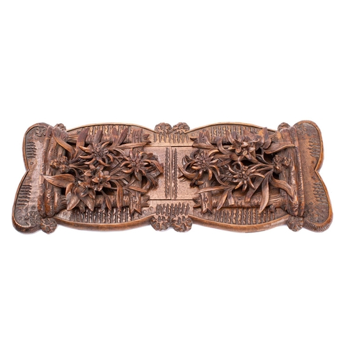 294 - A 'Black Forest' carved limewood book slide, probably Swiss, circa 1900; the hinged openwork ends mo... 