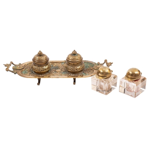 315 - A gilt brass encrier, second quarter 19th century; the twin inkwells with foliate cast hinged covers... 