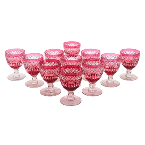 43 - A set of eleven cranberry and clear wine glasses and a part suite of twelve wine glasses, 20th centu... 