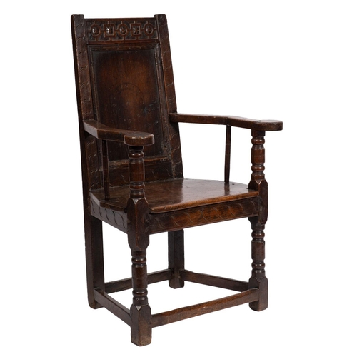 801 - A 17th Century oak Wainscot chair, the plain panel back with blind fret carved top rail with geometr... 