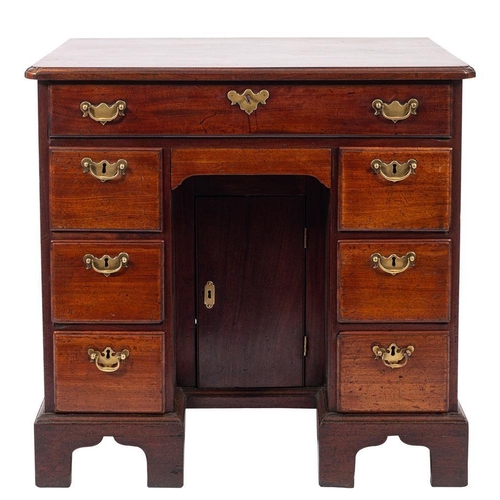 862 - A George III mahogany kneehole desk, the rectangular top with rounded corners and a moulded edge, fi... 