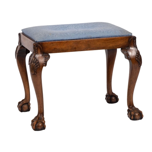 864 - A walnut dressing table stool in the George II taste, 20th century; with an upholstered slithered se... 