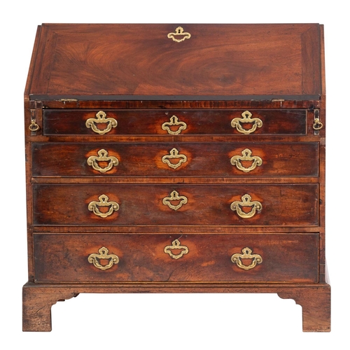 897 - A George II mahogany bureau; the sloping hinged fall enclosing a fitted interior with small drawers ... 