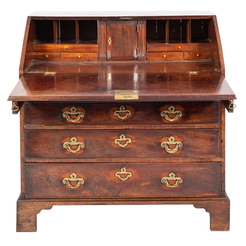 897 - A George II mahogany bureau; the sloping hinged fall enclosing a fitted interior with small drawers ... 