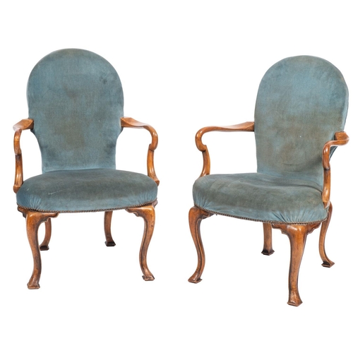 899 - A pair of walnut and upholstered elbow chairs in George II style, late C19th; the spade pad back abo... 