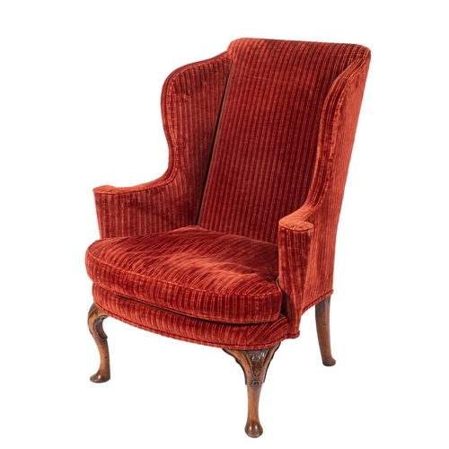 900 - A Queen Anne carved walnut wing frame armchair, with later elements; fully upholstered in wine colou... 