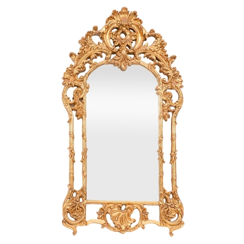 921 - A Rococo style gilt composite wall mirror, 21st century; the shell pediment above scrolled and folia... 