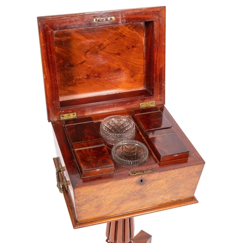 966 - A William IV flame mahogany teapoy, early 19th century; the sarcophagus case with gilt brass handles... 