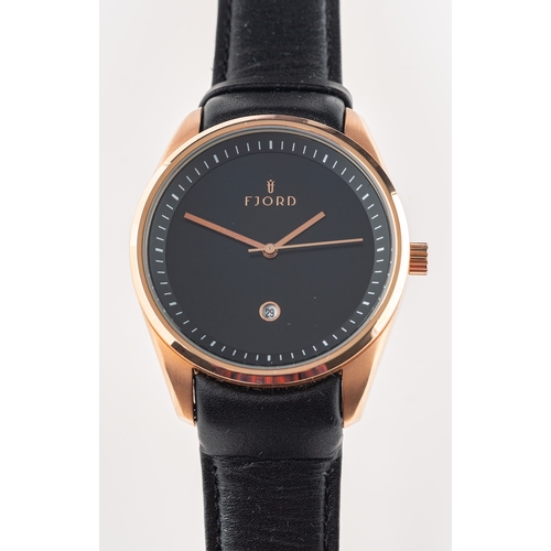 379 - Skagen a gentleman's wristwatch diameter 42mm. Fjord a gentleman's gold-plated wristwatch, the black... 