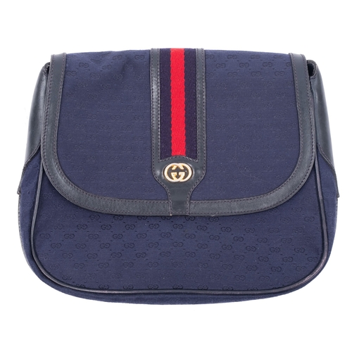 752 - Gucci. A  black leather and blue canvas shoulder bag, blue canvas 'GG' body with  red and blue webbi... 