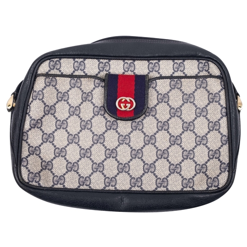 753 - Gucci. A black leather handbag, with printed 'GG' logo to body , black leather strap,  stamped to in... 