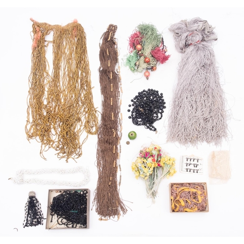 616 - A collection of early 20th century silk fringing, beadwork and textile accessories, hooks and eyes, ... 