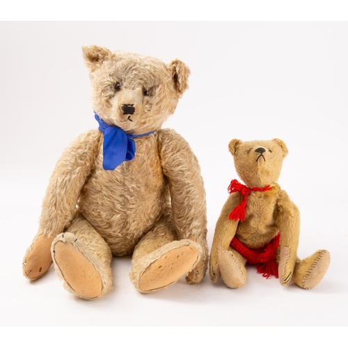 656 - An early 20th century blonde plush Teddy bear with glass eyes, stitched nose and mouth over a humped... 