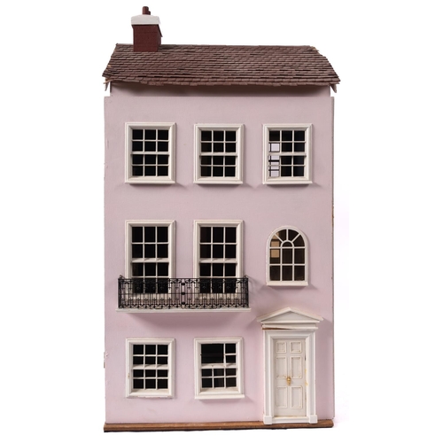 663 - A 20th century dolls house in the Georgian style, the three story opening front enclosing three room... 