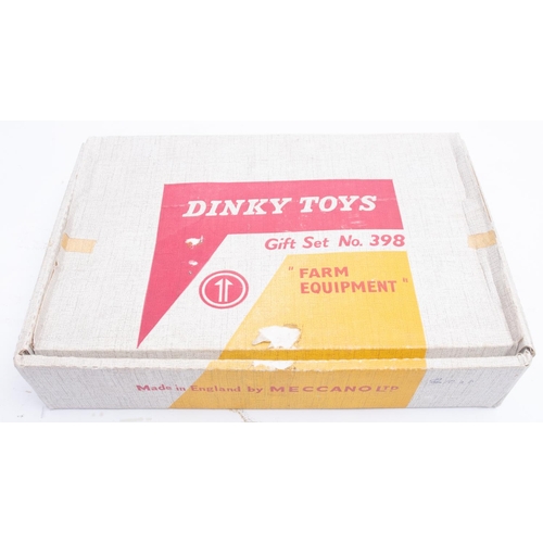 667 - Dinky 398 'Farm Equipment' Gift Set. comprising Massey Ferguson Tractor red with yellow hubs, driver... 