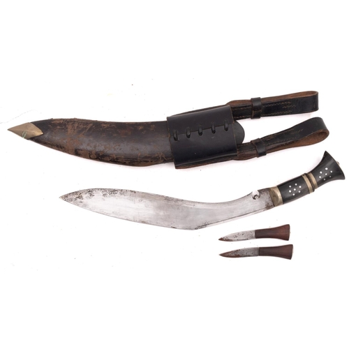 121 - A horn handled Kukri in black leather scabbard.