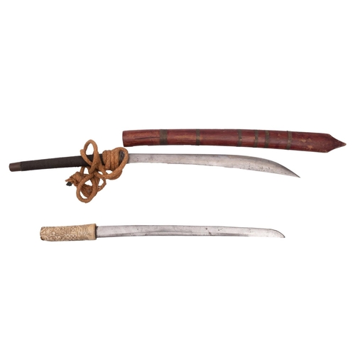 122 - A Burmese Dha short sword, the shaped single edge blade over a circular brass hilt and wire bound gr... 