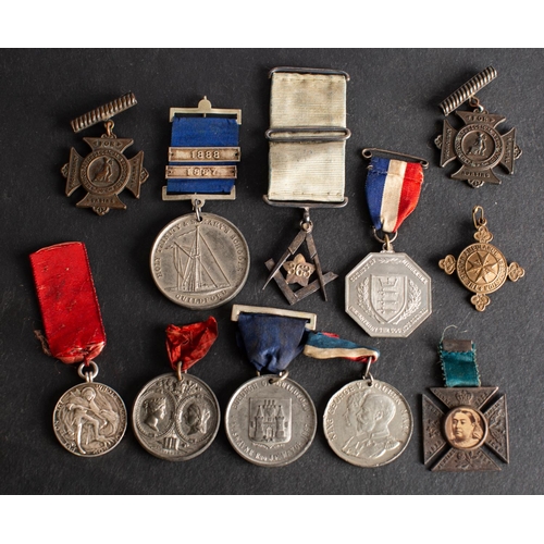 183 - A group of Victorian and later Jubilee, Long Service and Association medals, including a silver Cate... 