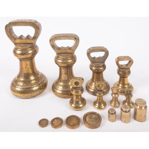 21 - A set of seven brass bell weights graduated from 7lb, together with eight other various brass weight... 