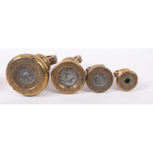 21 - A set of seven brass bell weights graduated from 7lb, together with eight other various brass weight... 