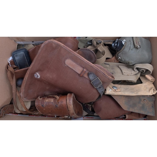 213 - A quantity of WWII and later British and USA equipment, including canvas bags, two trenching shovels... 