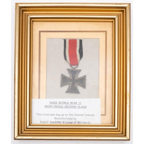 218 - A WWII Iron Cross 2nd Class, mounted in a picture frame with inscription 'This cross was dug up on t... 