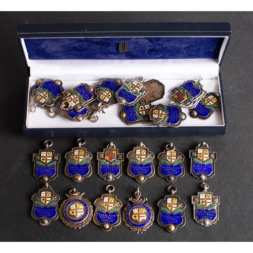 25 - A collection of twenty- two Excelsior Football League silver and enamel  prize medallions dating bet... 