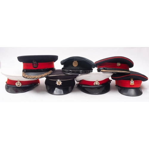 253 - A group of seven various peaked caps, including two Royal Marines peaked caps, a Royal Corps of Tran... 