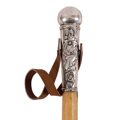 26 - An Argentinian silver mounted  Rebenque (gaucho riding whip), the broad leather  strap and plain sha... 