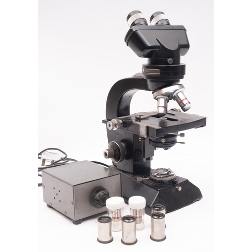 283 - Cook & Troughton & Simms. A black lacquer binocular microscope, serial number M25731, with coarse/ f... 