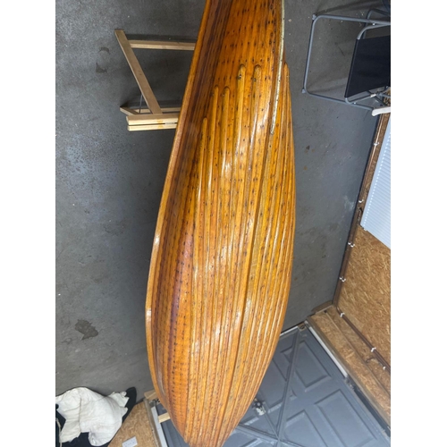 367 - An early 20th century Canadian cedar strip canoe of traditional construction with three seats, one w... 