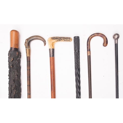 42 - A group of five various walking sticks, comprising an antler handled stick, two horn handled sticks,... 