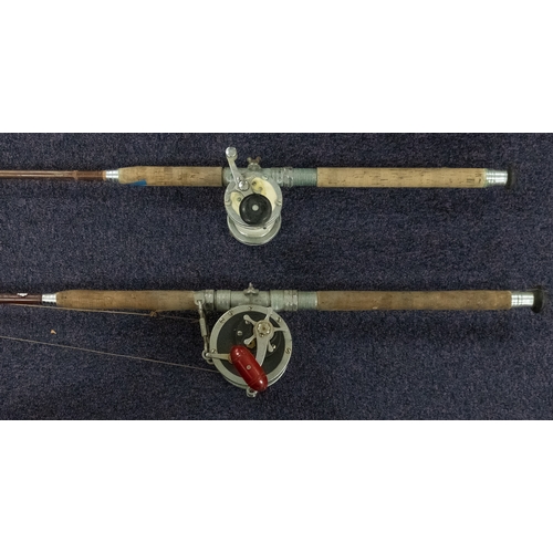 330 - Two hollow glass rods, one with a Penn Senator 9/0 reel, the other with an unsigned French reel (2)