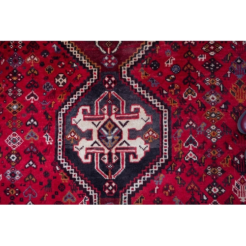 1062 - A Qashgai carpet, the rose field with triple hexagonal stepped central medallions, all over designs ... 