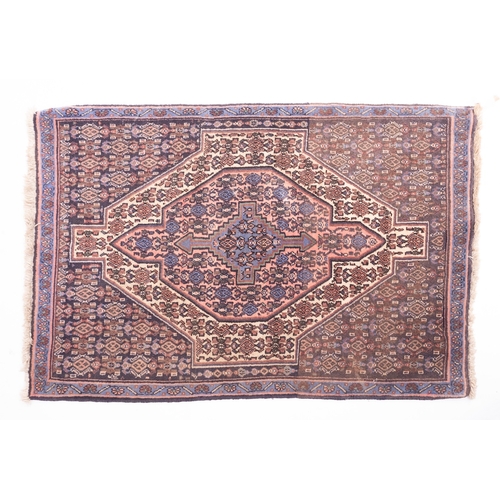 1063 - A Hamadan rug, the field with a central rose pointed panel, stepped and pointed cruciform medallion ... 