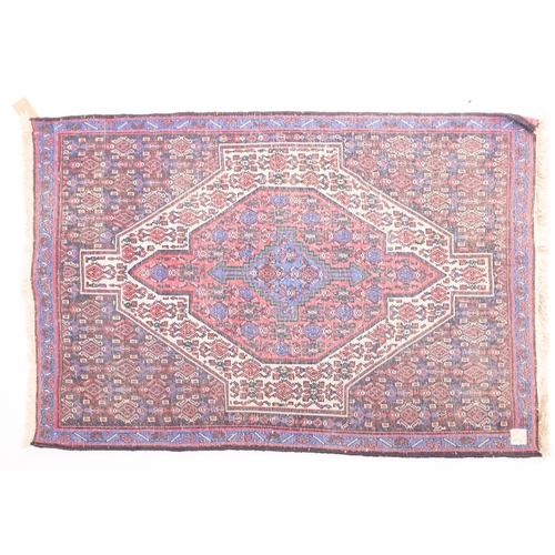 1063 - A Hamadan rug, the field with a central rose pointed panel, stepped and pointed cruciform medallion ... 