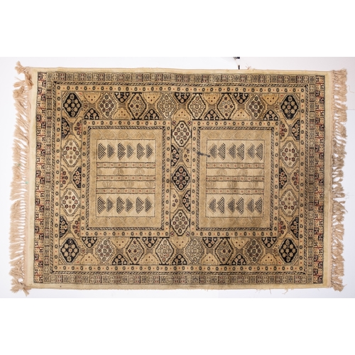 1064 - A Kurdish rug, the brick red field with ivory and pastel geometric medallions, enclosed by a main iv... 