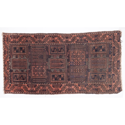 1066 - A Balouchistan rug, the serrated oblong panelled field with geometric designs, enclosed by a main ro... 