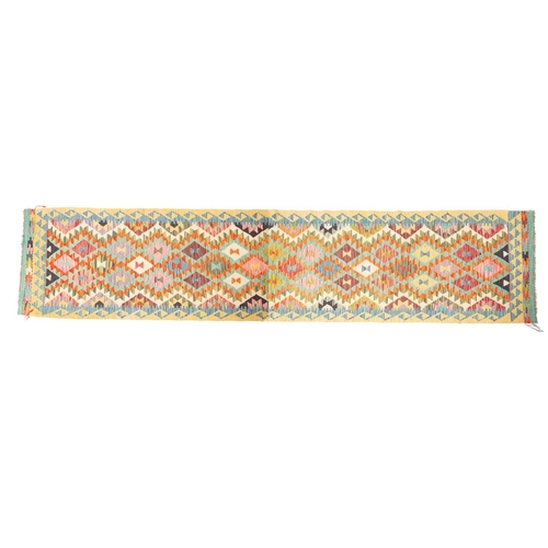 1071 - An Anatolian Turkish Kelim, the serrated lozenge all over field in multiple bright colours, within a... 