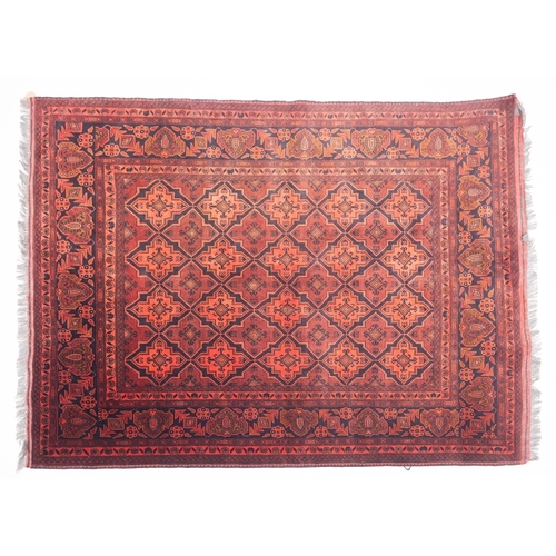 1078 - A Turkoman rug, the shaded wine and rose shaped lozenge panelled field with geometric hooked lozenge... 