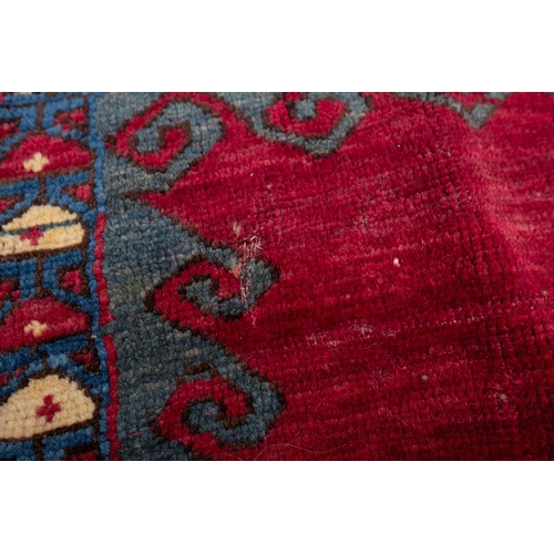 1079 - A Kasak rug, the wine field with triple indigo and pastel blue stepped cruciform medallions, surroun... 