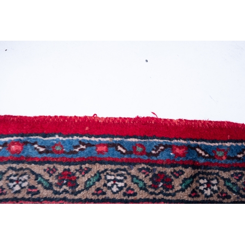 1095 - A Hamadan carpet, the red shaped lozenge field with a central indigo lozenge pole medallion, all ove... 