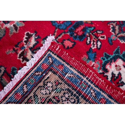 1095 - A Hamadan carpet, the red shaped lozenge field with a central indigo lozenge pole medallion, all ove... 