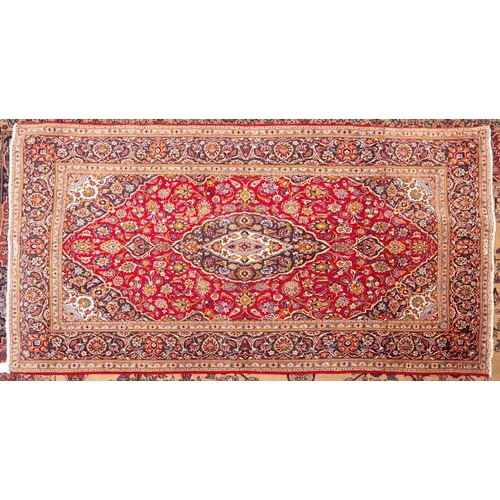 1097 - A Shadsar signed Kashan rug, the shaded wine cartouche field with a cartouche pendant medallion, all... 