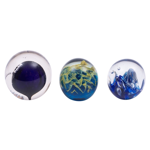 21 - Four signed glass paperweights, including a domed example by Michael Hook with central blue sphere a... 