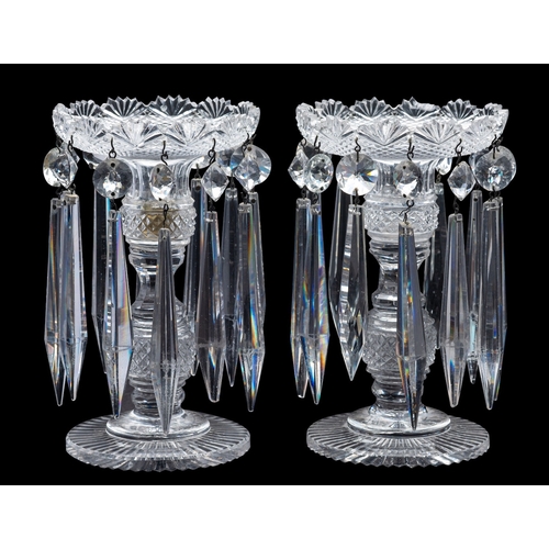 5 - A pair of cut-glass table lustres with knopped and faceted stems, on sunburst bases and hung with pr... 