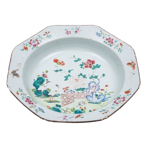 54 - A Chinese famille rose octagonal deep dish/basin painted with a fenced garden with cranes, butterfli... 